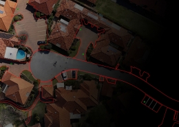 Orthomosaic map of a residential area with a CAD overlay for property boundaries and roads.